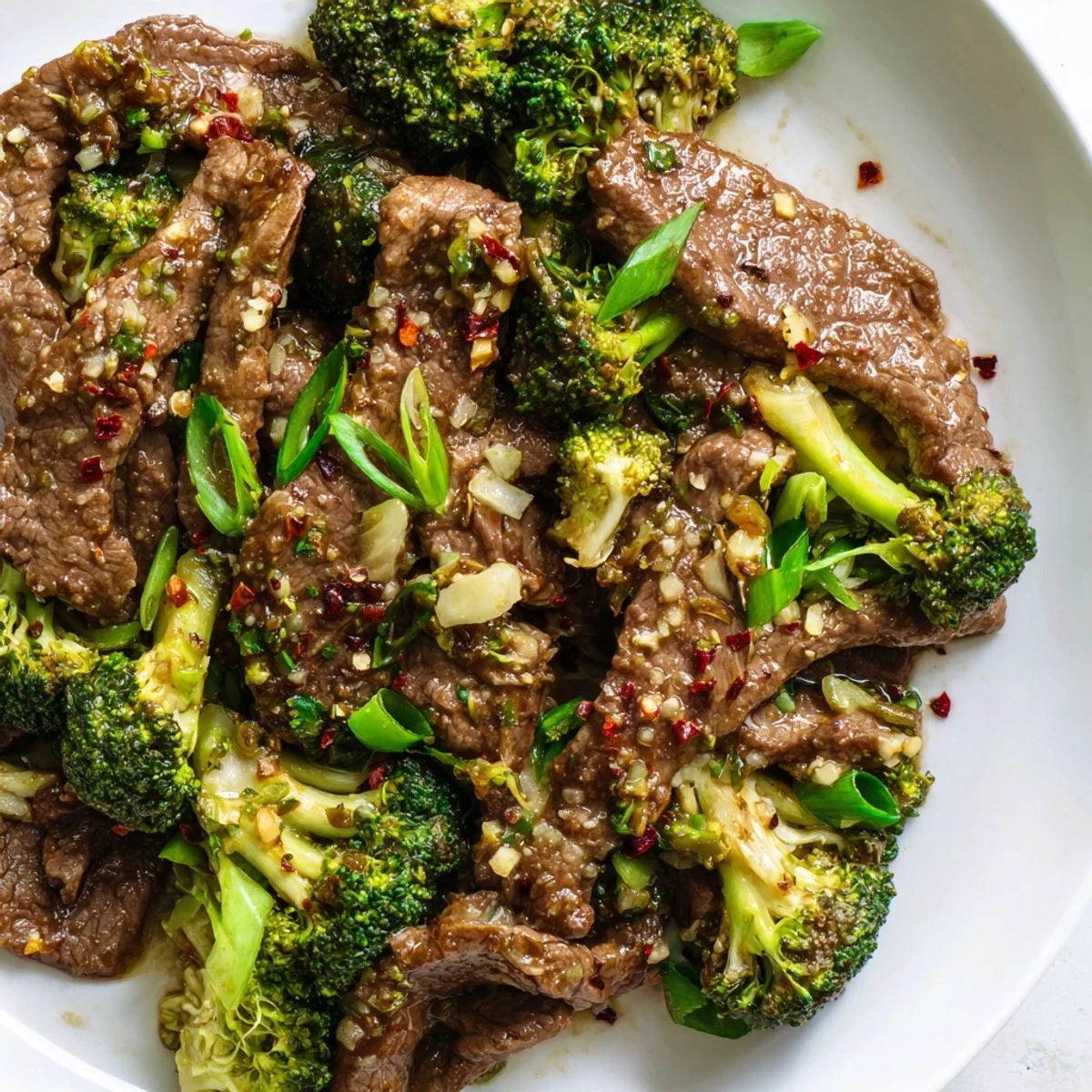 Served alongside fluffy cauliflower rice, this Keto Friendly Beef and Broccoli Stir Fry is garnished with fresh scallions and sesame seeds.