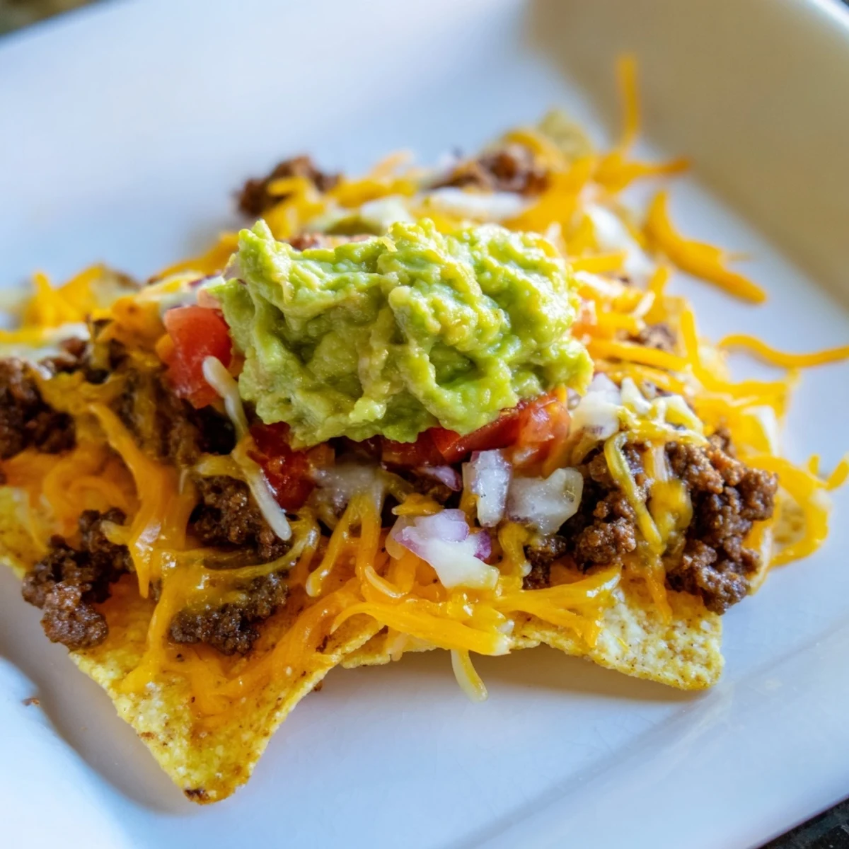 Crispy chips loaded with seasoned beef, melted cheddar, and Monterey Jack, topped with fresh guacamole and zesty salsa.