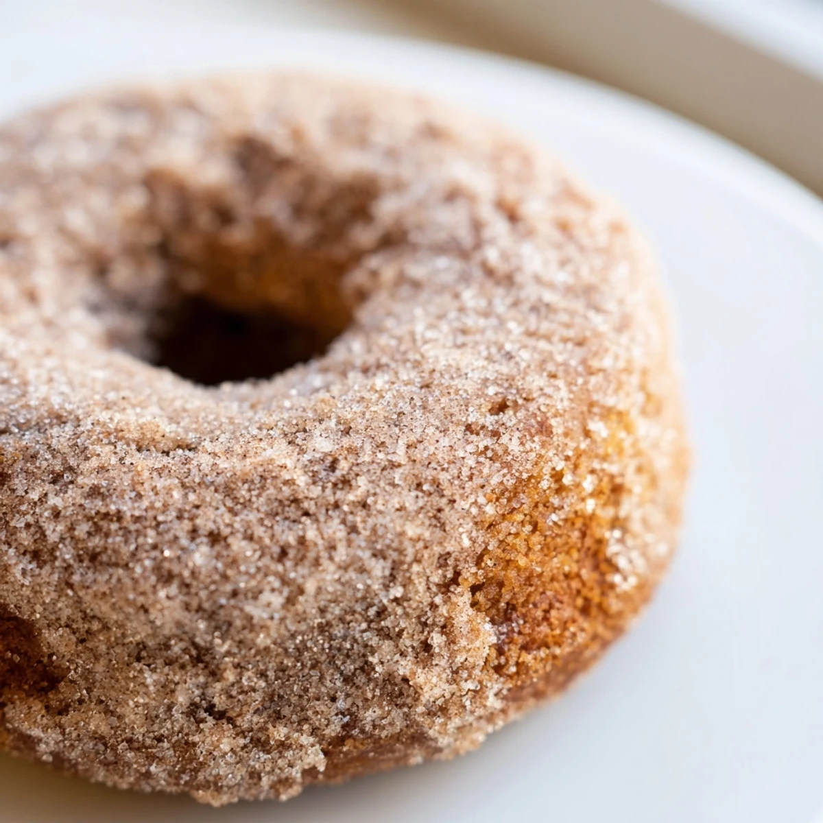 A platter of glazed Baked Apple Cider Donuts ready to be served for a cozy fall breakfast or afternoon treat.