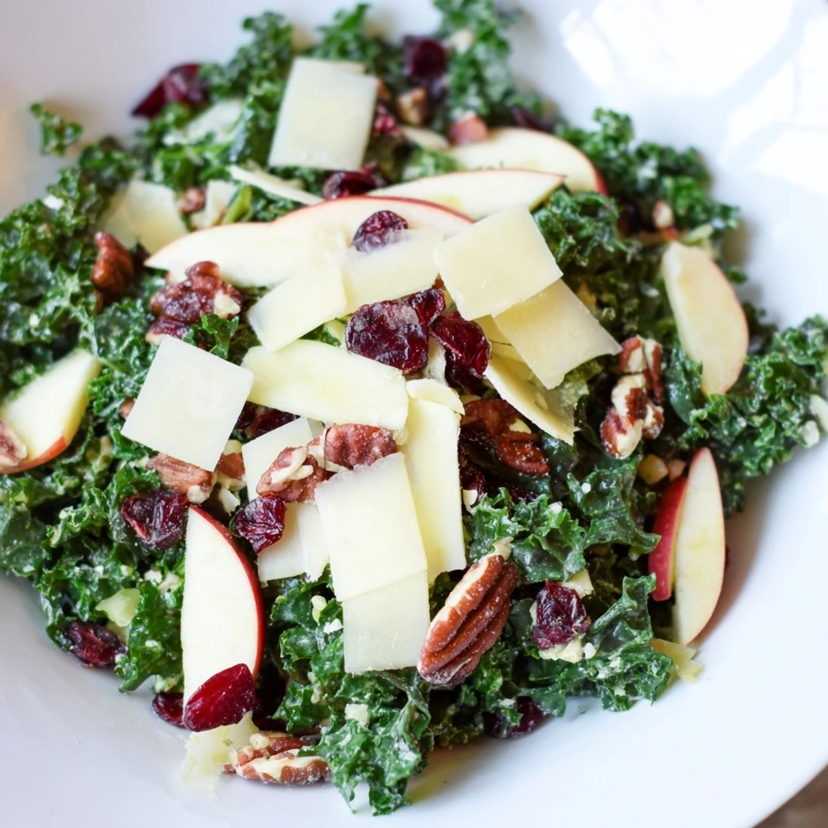 This Winter Kale Salad with Apple and Cheddar is tossed with toasted walnuts and a tangy vinaigrette, ready for a healthy lunch.