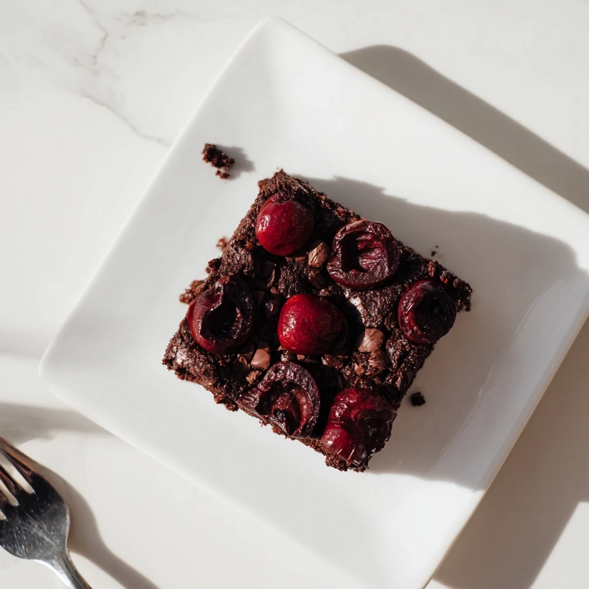 Juicy roasted cherries folded into fudgy Roasted Cherry Brownies batter in an 8-inch square pan.