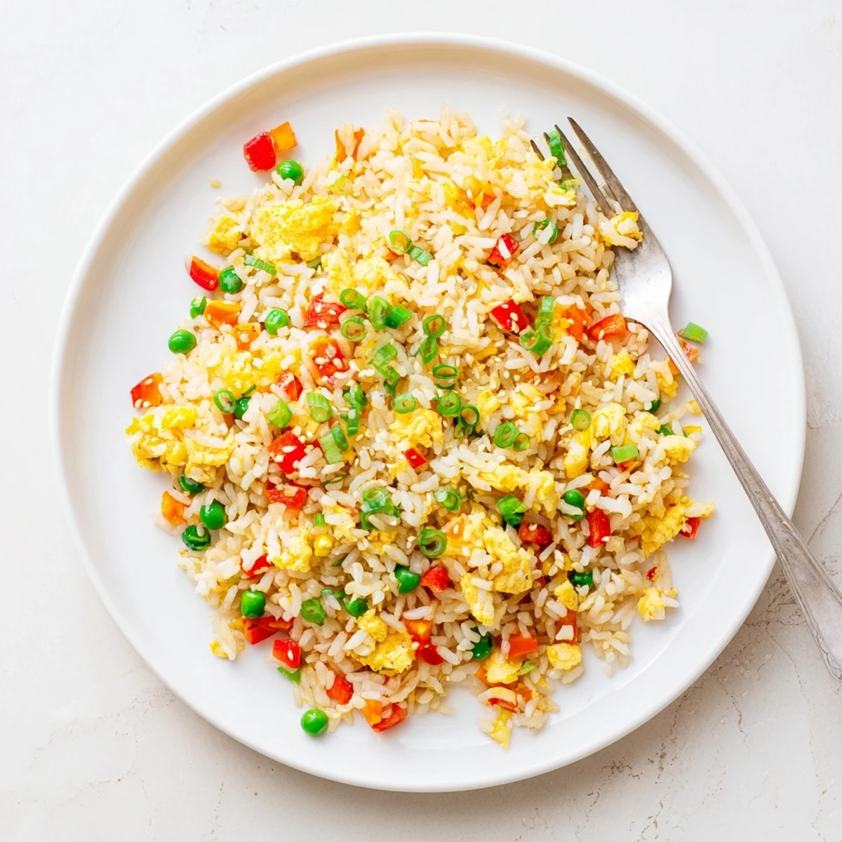 Savory Fried Rice served in a bowl, garnished with fresh green onions for a delicious meal.