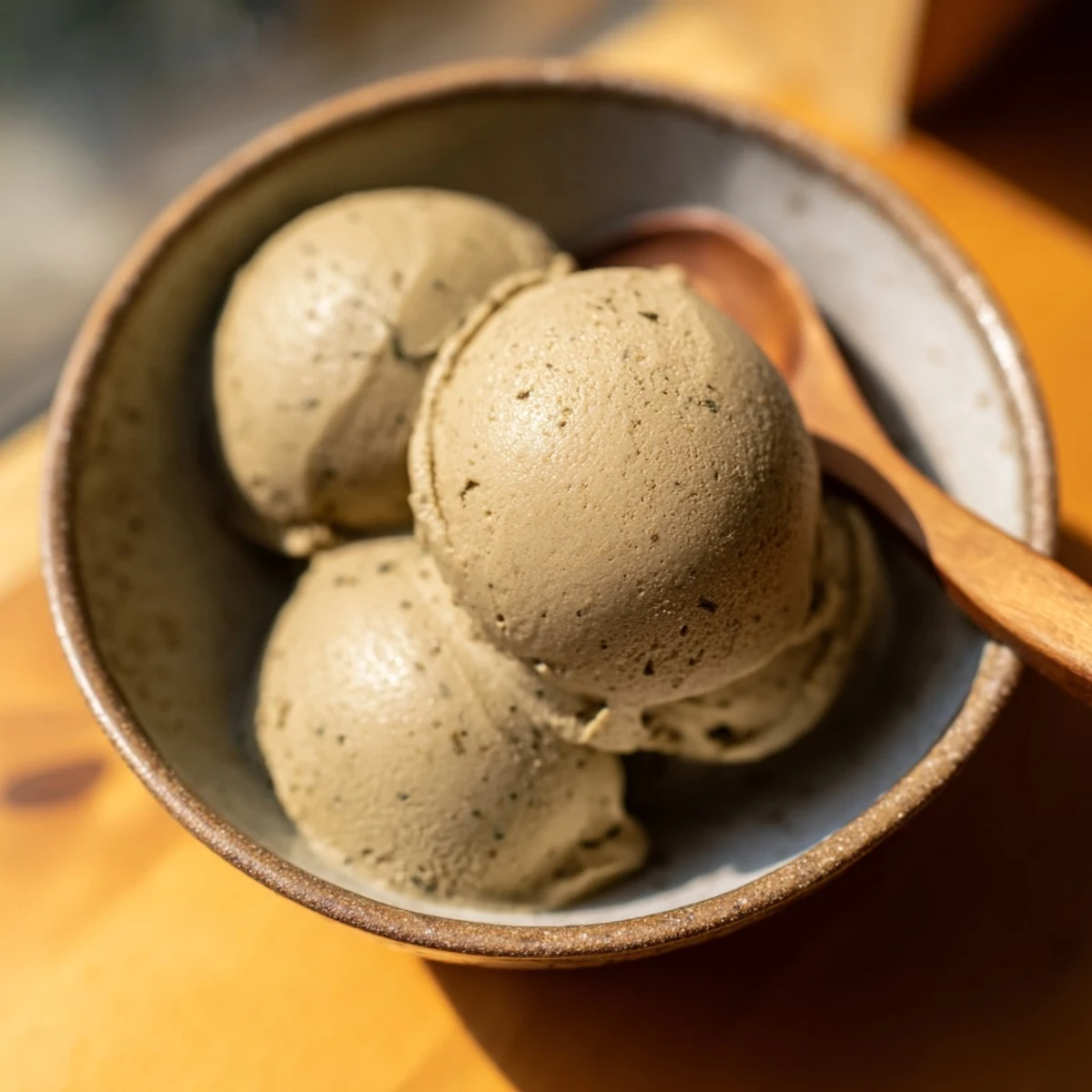 Delicious Hojicha Ice Cream in a rustic ceramic dish, perfect for an elegant Japanese-inspired dessert presentation.