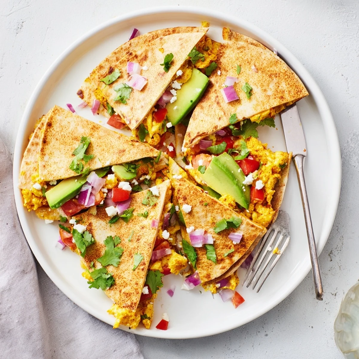 Golden-brown Spicy Avocado Egg and Three Cheese Quesadillas wedges steam on a wooden board, revealing melted Monterey Jack and cheddar with bright avocado slices.