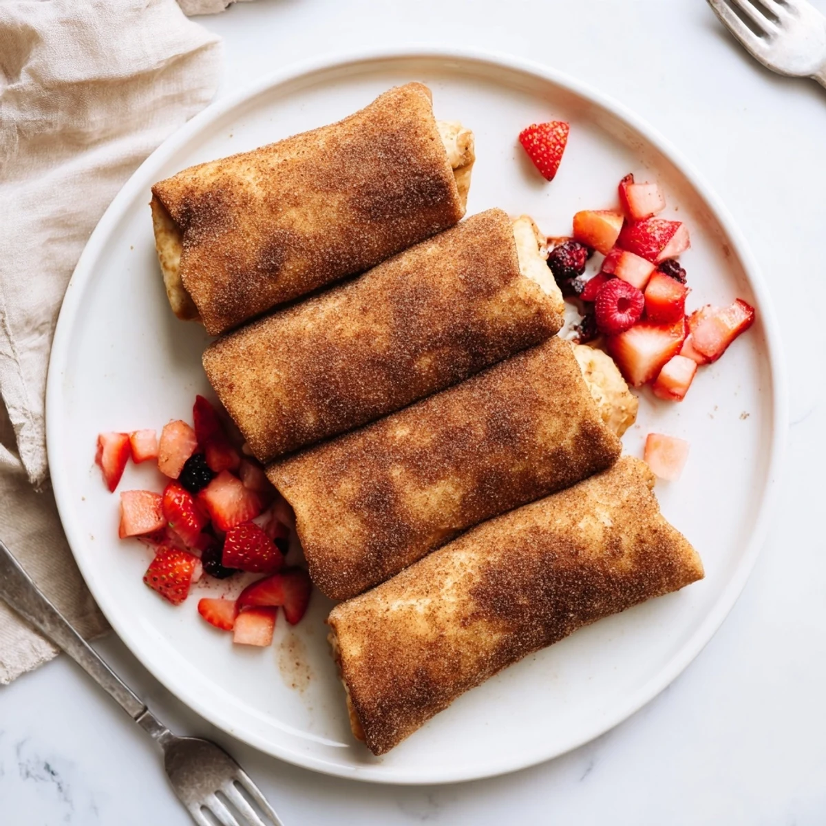 A hand holding a crispy Cheesecake Dessert Chimichangas Cinnamon Sugar Delight, revealing creamy filling inside.