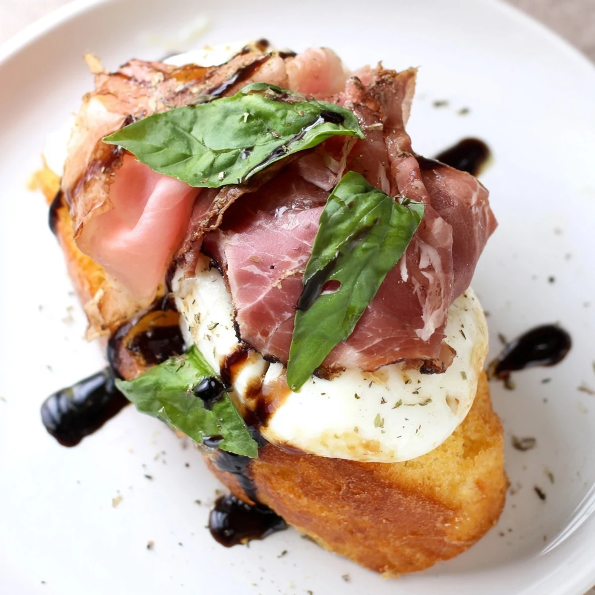 Golden Mozzarella Beef Prosciutto Crostini are ready to serve on a wooden board for an appetizer spread.
