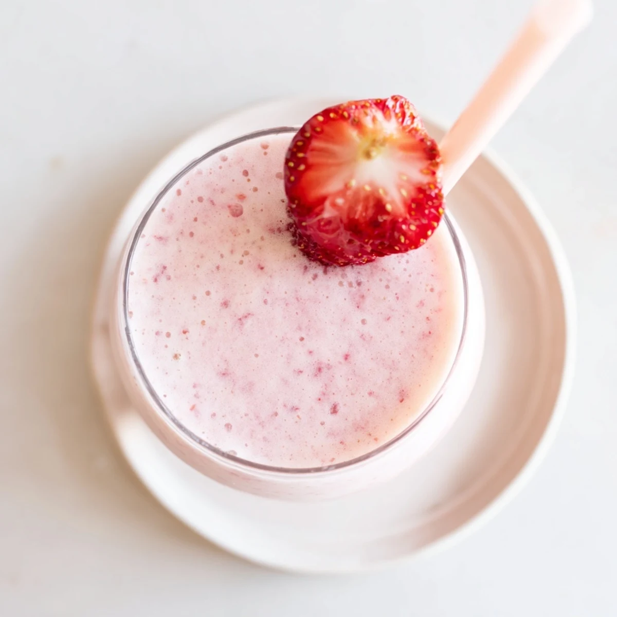 Healthy breakfast smoothie blended with Greek yogurt and fresh strawberries garnished with whole berries