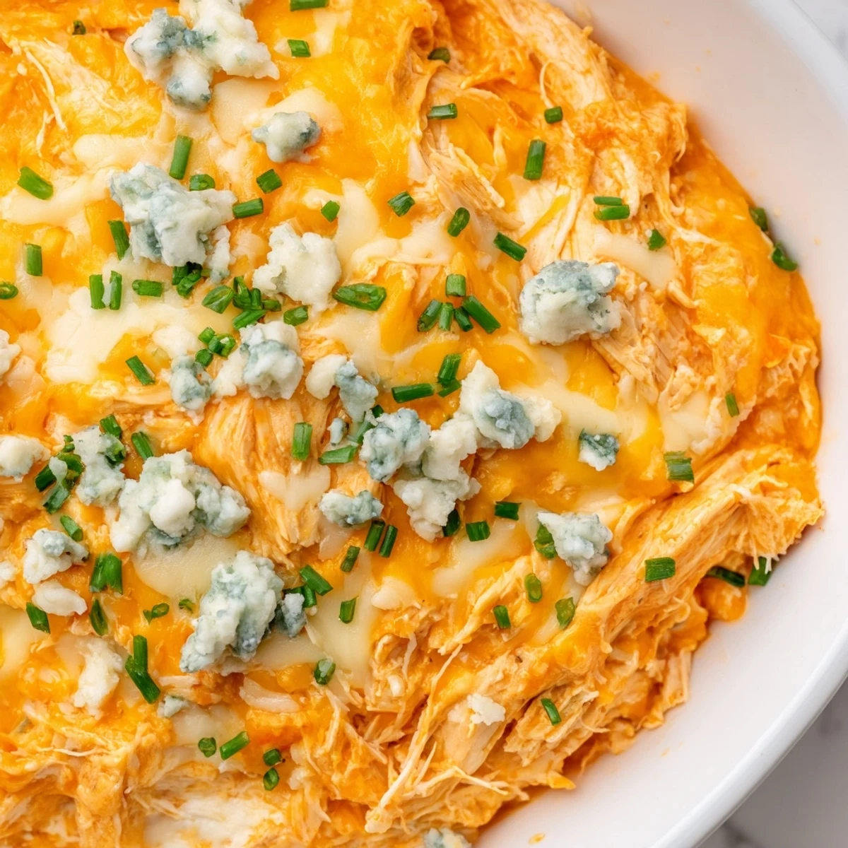 Warm and spicy buffalo chicken dip served with crispy tortilla chips and celery