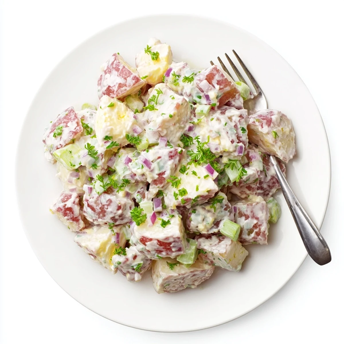 Vibrant red potato salad featuring diced potatoes, red onion, and tangy mayonnaise dressing