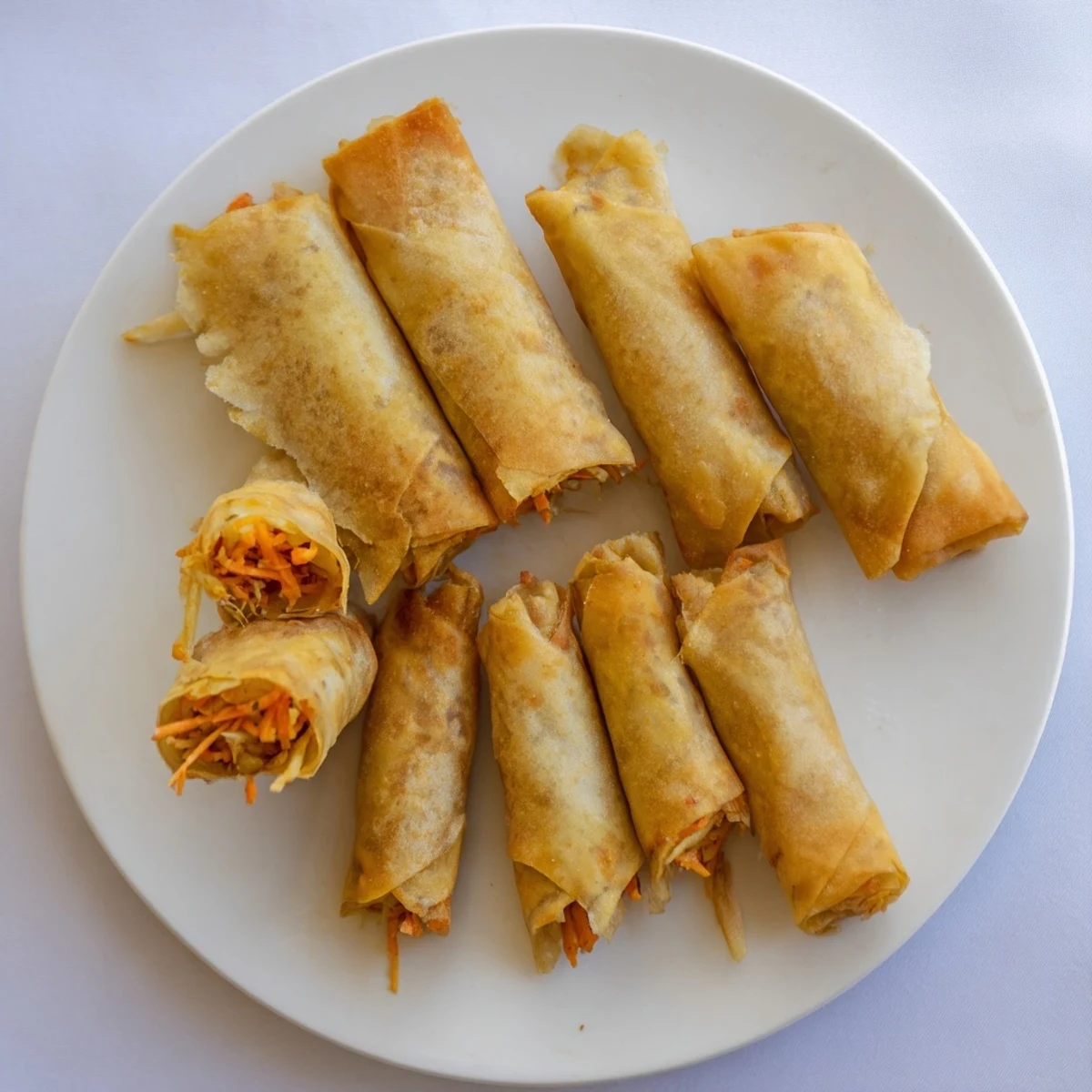 Close-up of fried Vietnamese crispy rice paper spring rolls served with dipping sauce