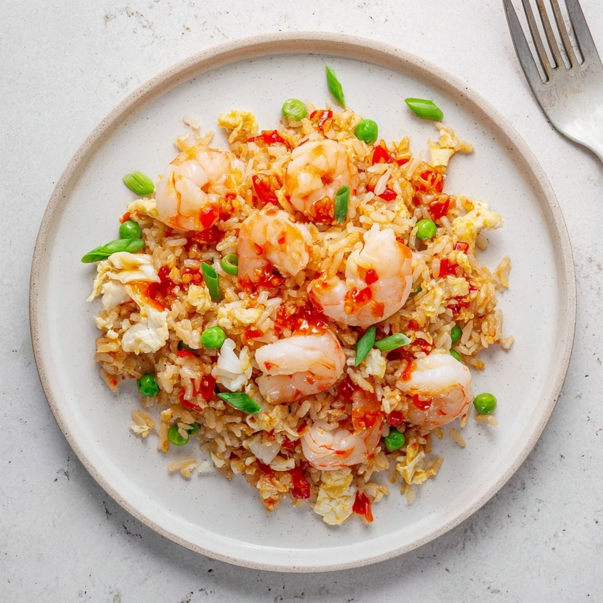 Golden fried rice studded with pink shrimp and lump crab drizzled with vibrant red garlic chili oil