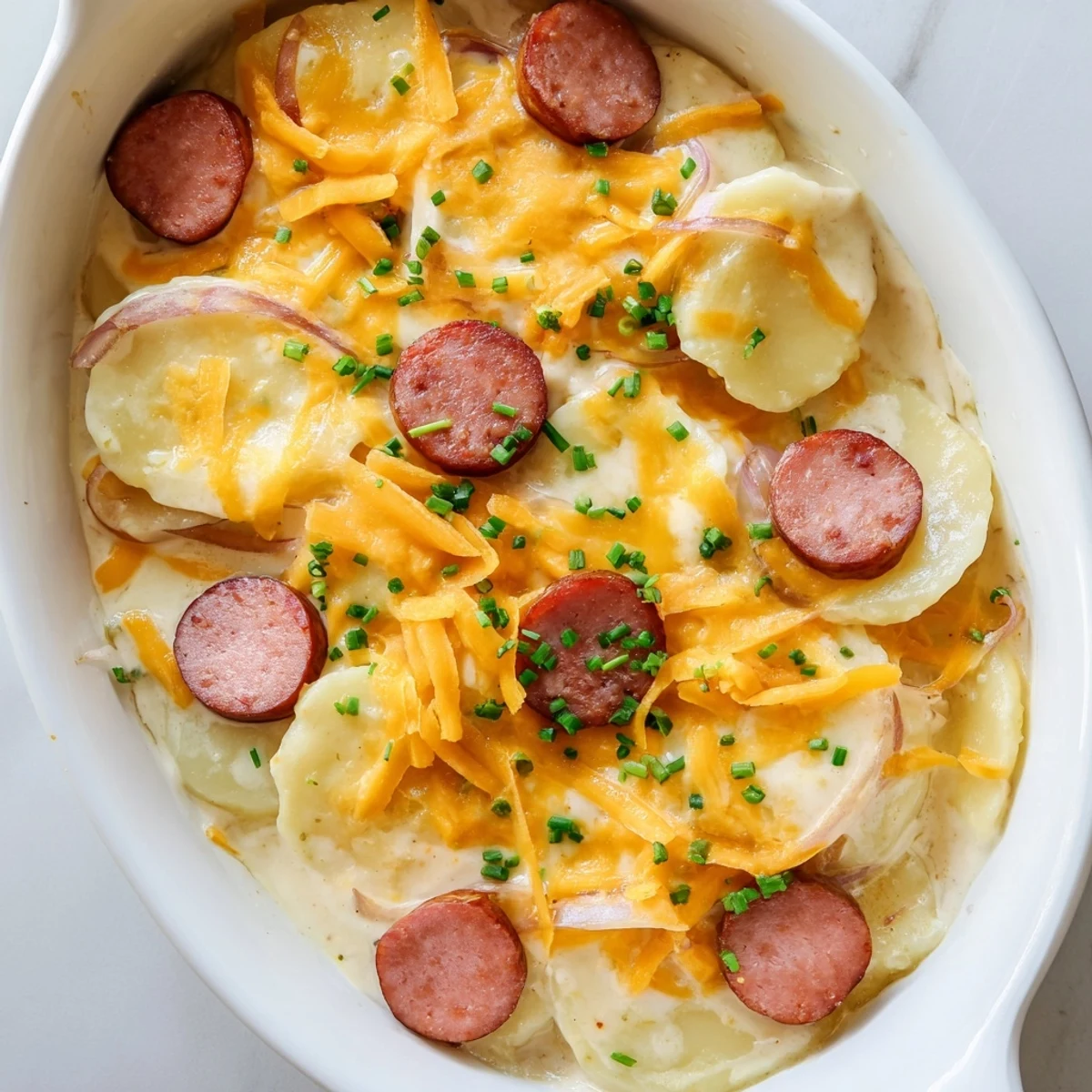 Golden cheesy Crock Pot Pierogi Casserole with Kielbasa bubbling with melted cheddar and smoky sausage slices
