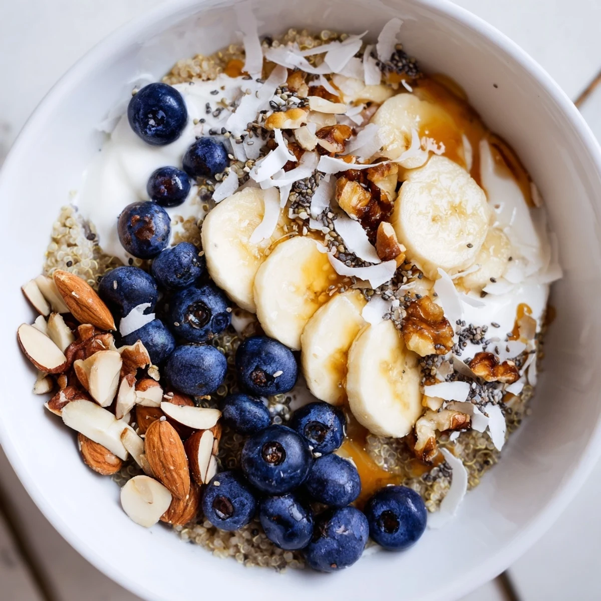 Nourishing blueberry quinoa breakfast bowl sprinkled with chia seeds and shredded coconut flakes