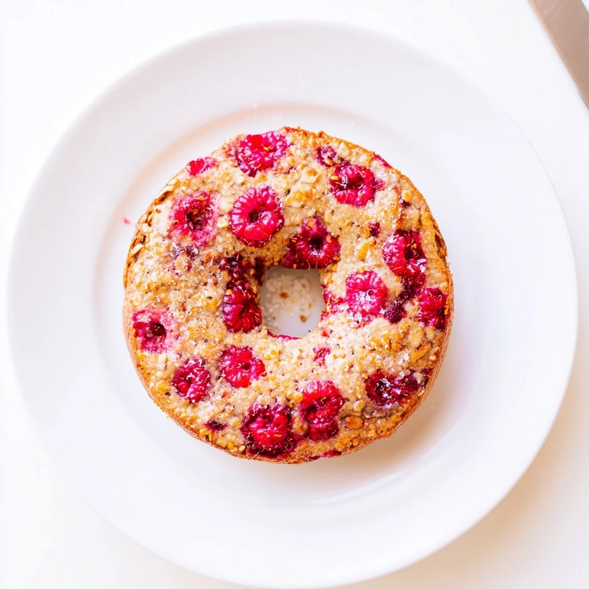 Freshly baked raspberry sourdough bagels with pink raspberry speckles and golden crust