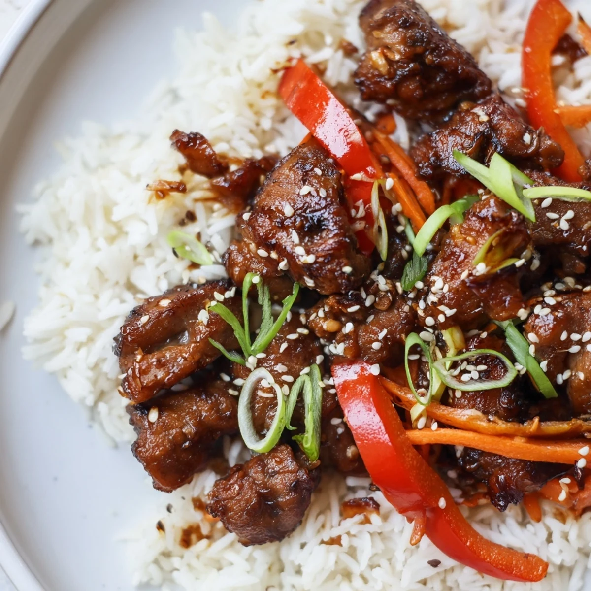 One Pan Korean BBQ Chicken and Rice with colorful vegetables steaming hot in a deep skillet