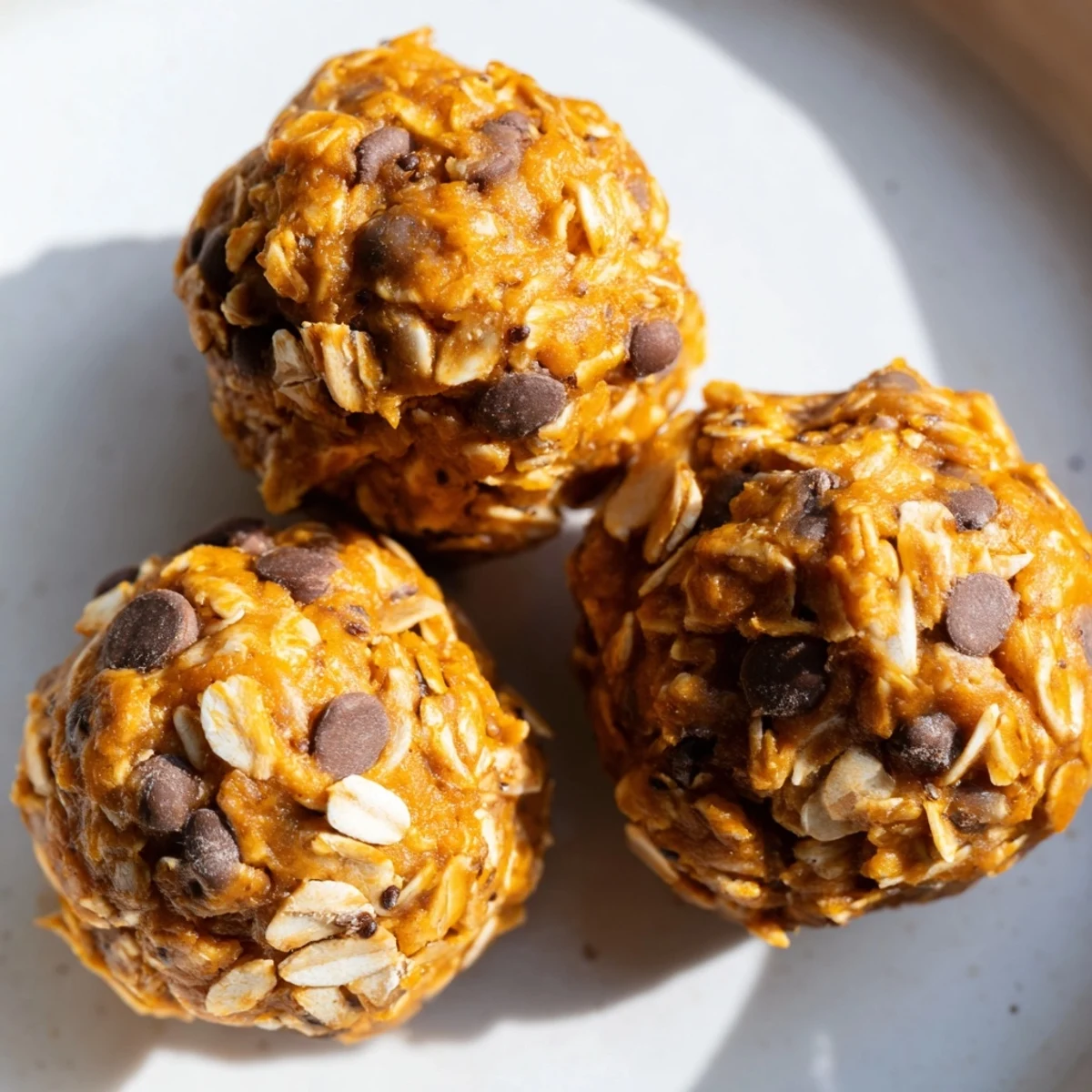 Creamy no bake pumpkin protein balls rolled in oats ready for healthy fall snacking