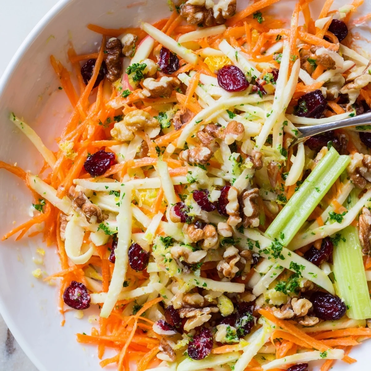 Refreshing crunch and parsley garnish highlight Crunchy Apple Carrot Salad With Creamy Citrus Dressing