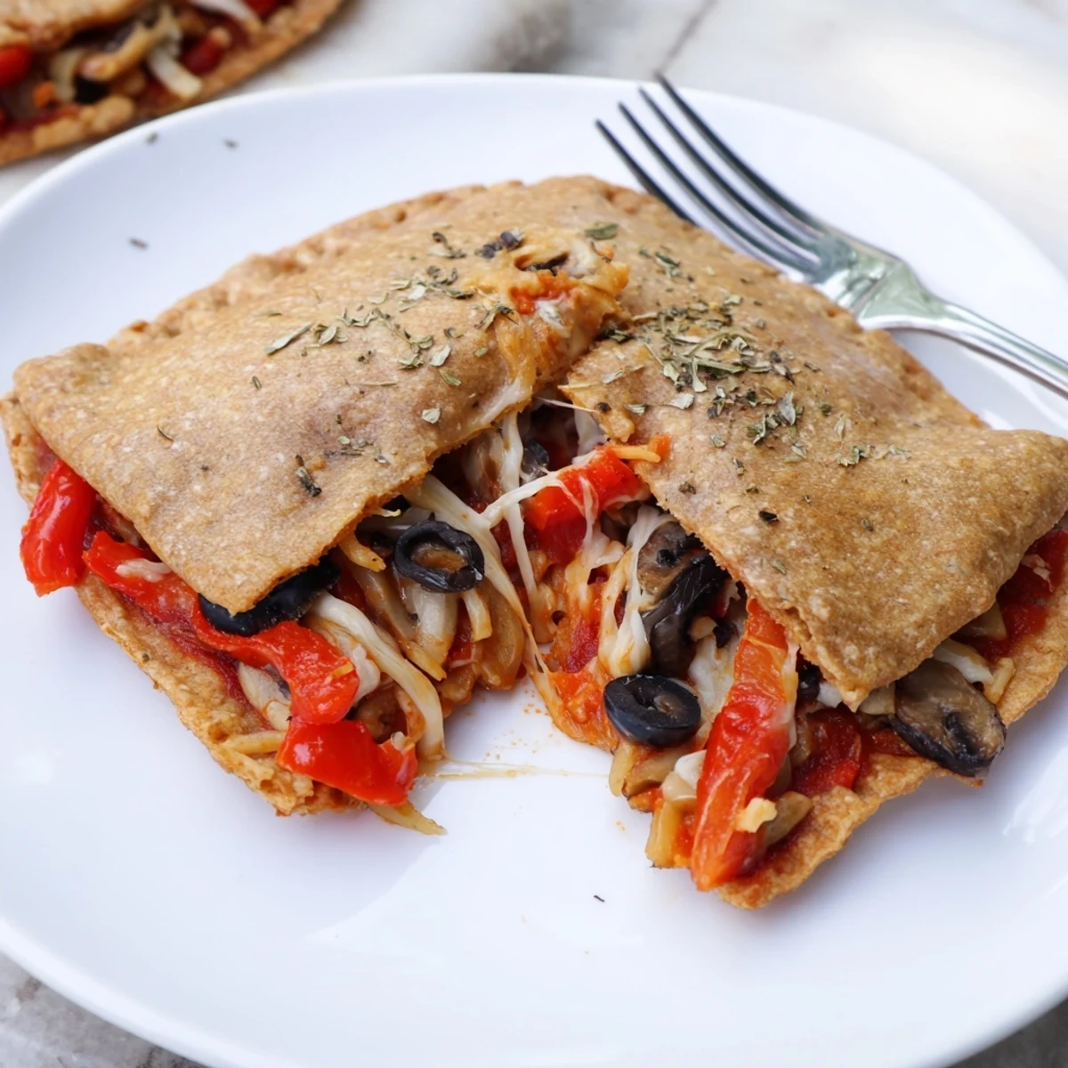 Campfire browned Pie Iron Pizza Pockets with tangy marinara and fresh basil.
