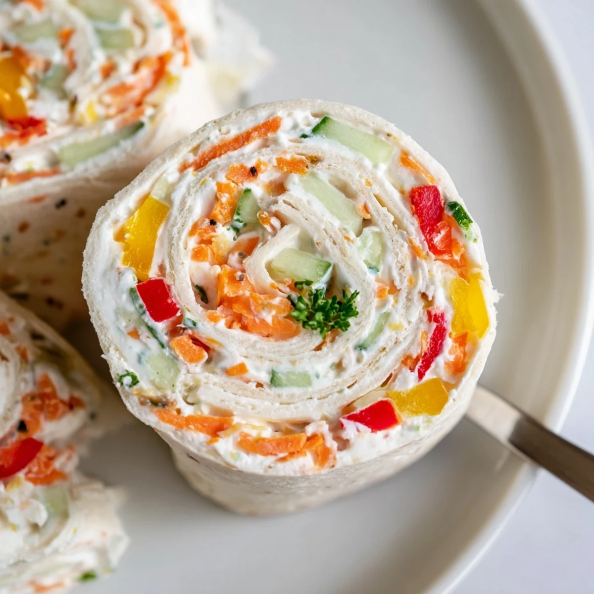 Cold Vegetable Tortilla Roll Ups with tangy cream cheese spread, garnished parsley