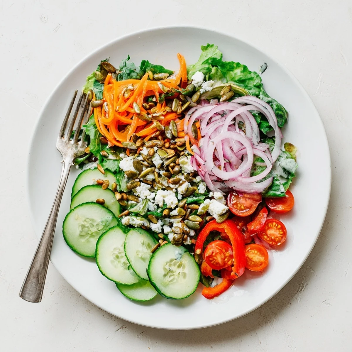 Vibrant garden salad with shredded carrots red onion and optional feta cheese topping