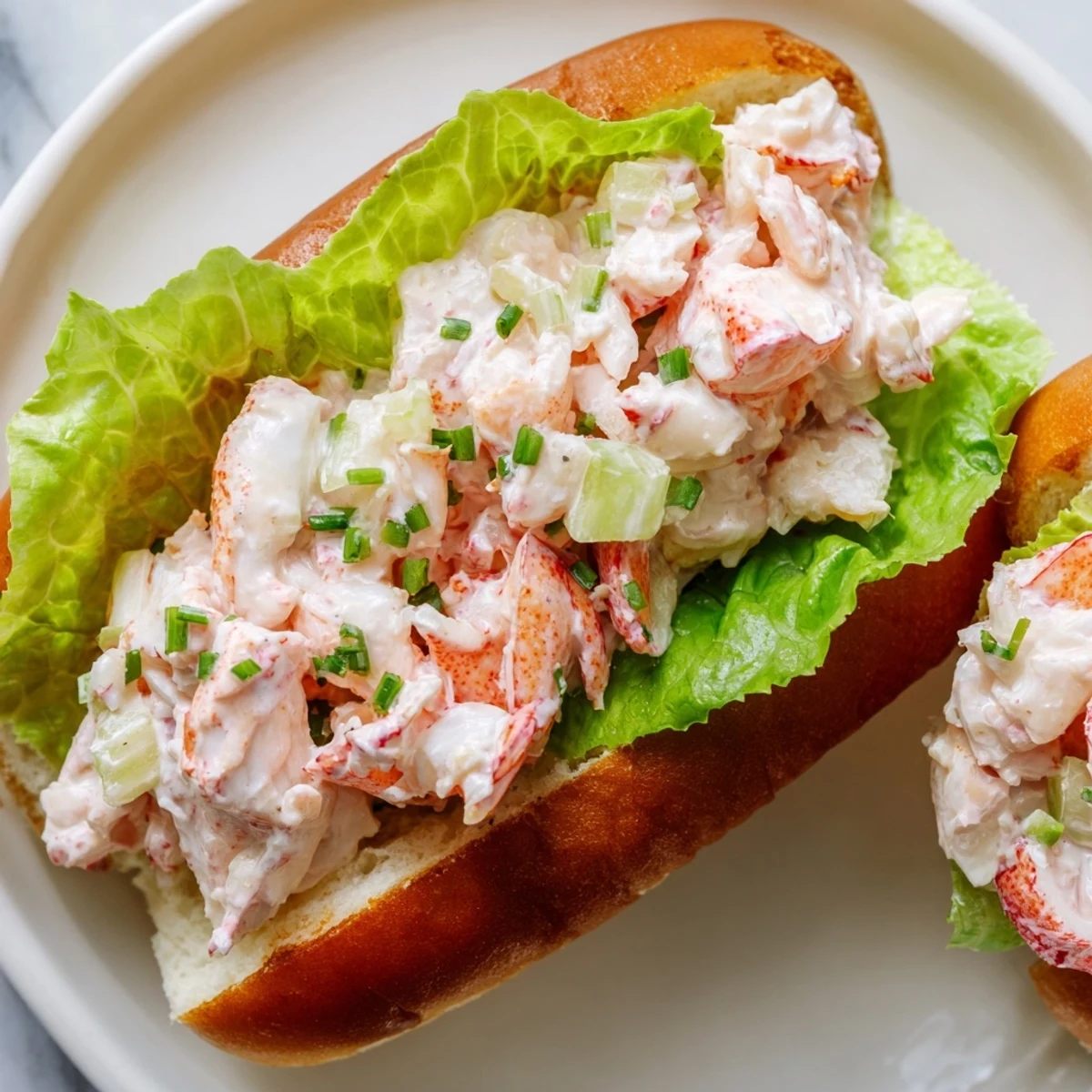 Buttery hot dog bun piled high with tender lobster meat and crisp celery