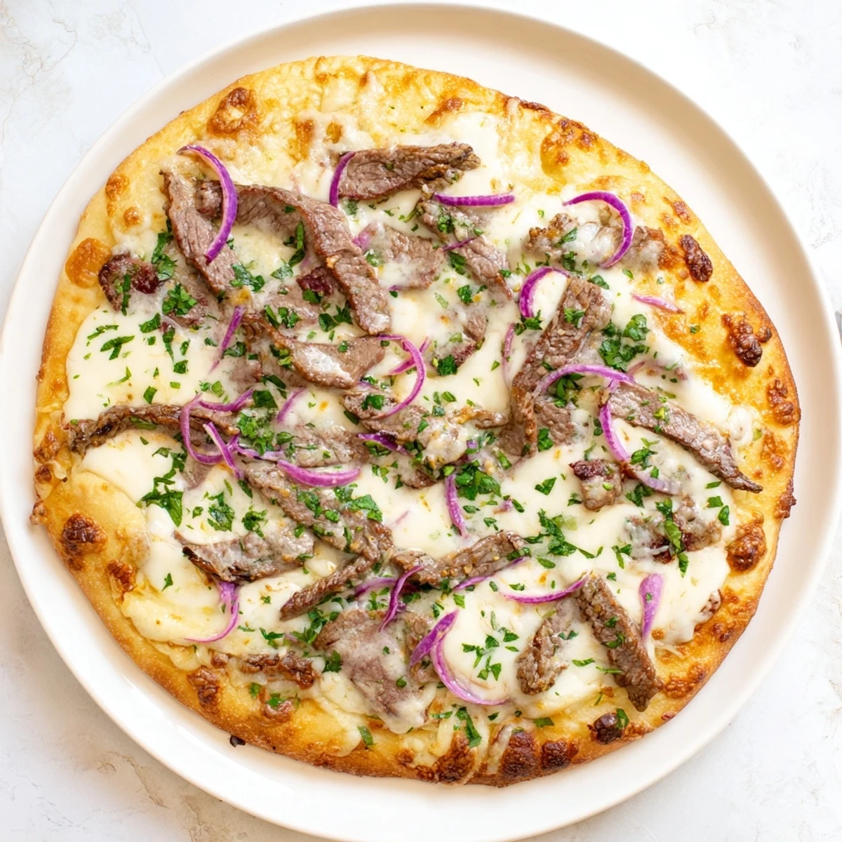 Rich American-Italian fusion pizza featuring beef alfredo with melted provolone and mozzarella cheese