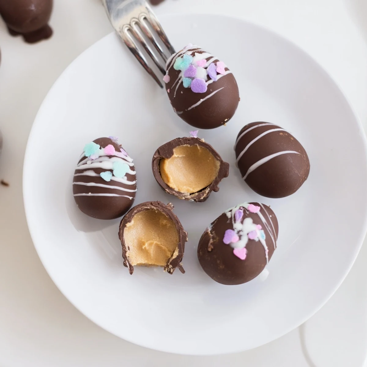 Homemade Peanut Butter Eggs with glossy chocolate coating, chilled on parchment