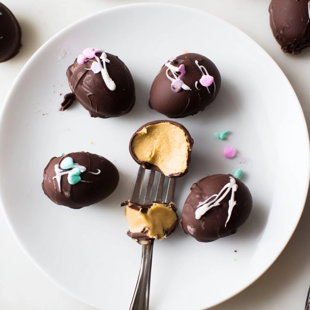 Hand-held Homemade Peanut Butter Eggs with velvety filling, ready to refrigerate