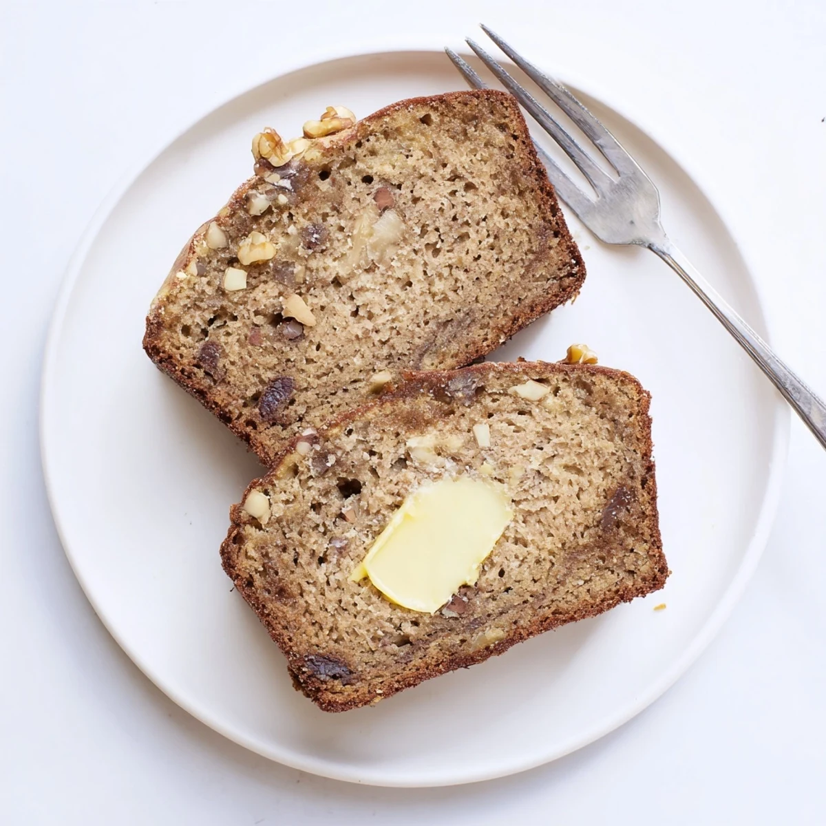 Sliced Banana Bread Delight releasing cinnamon aroma, served with steaming coffee.