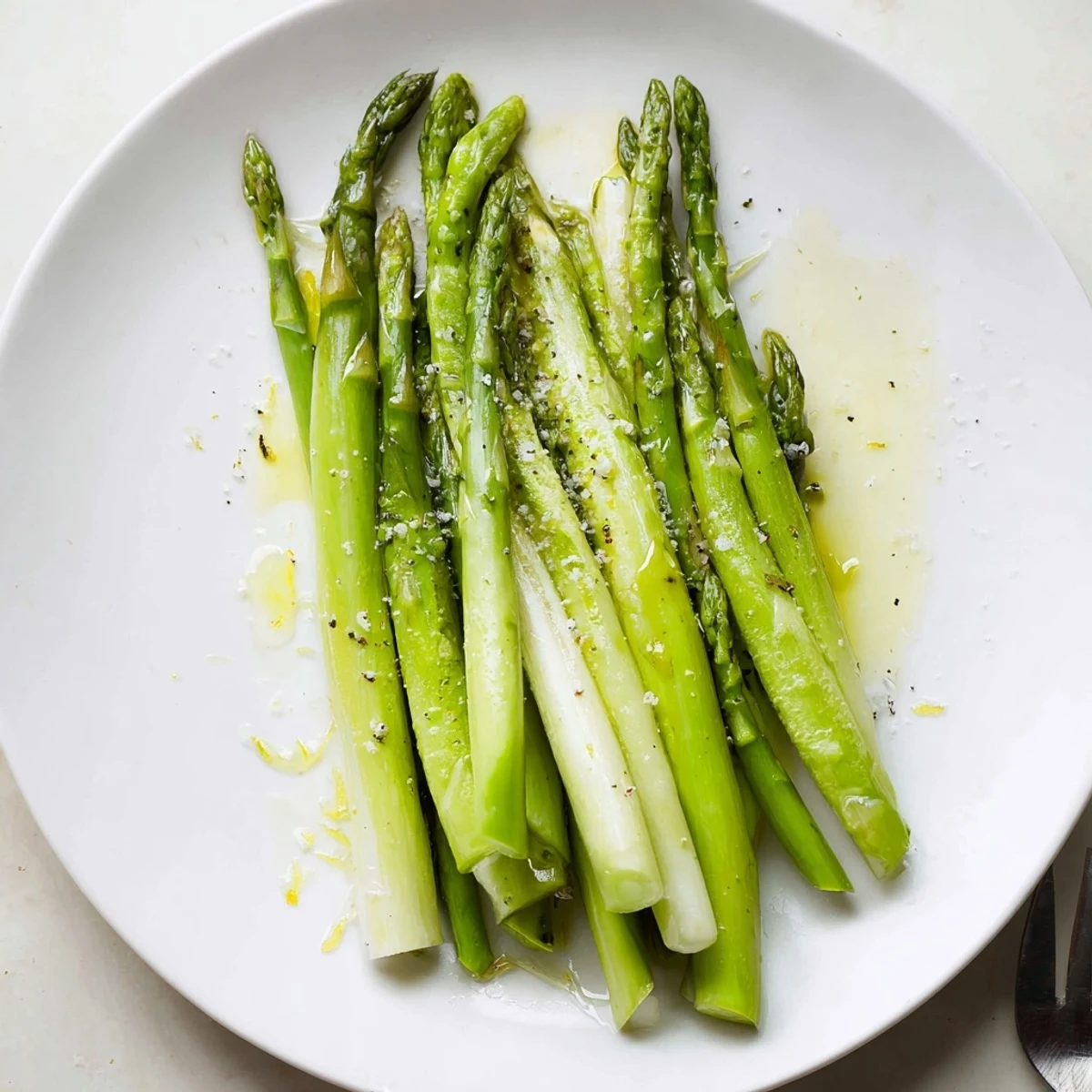 Steamed Asparagus glistening with olive oil and lemon, bright green tender stalks