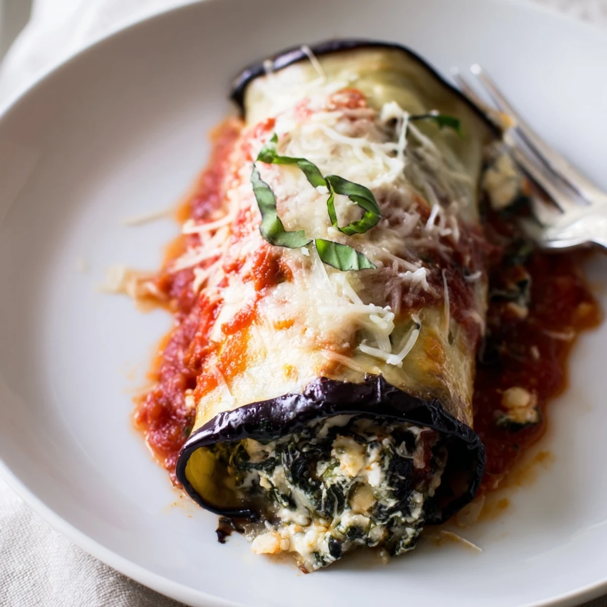 Healthy Eggplant Rollatini baked golden with marinara, melted mozzarella and basil