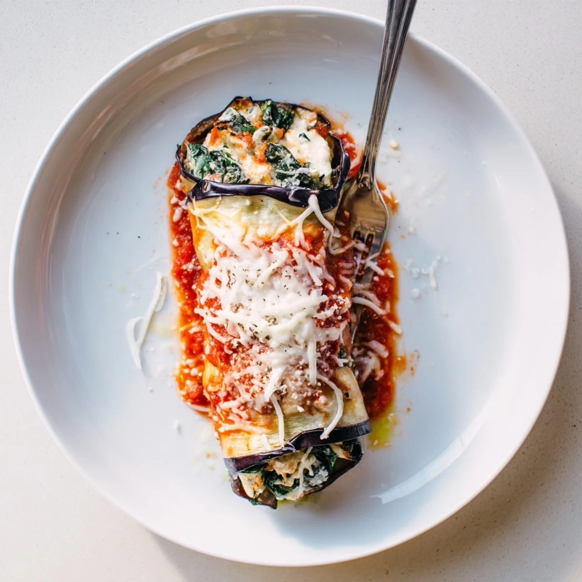 Sliced Healthy Eggplant Rollatini arranged seam-side down, steaming, ready to serve