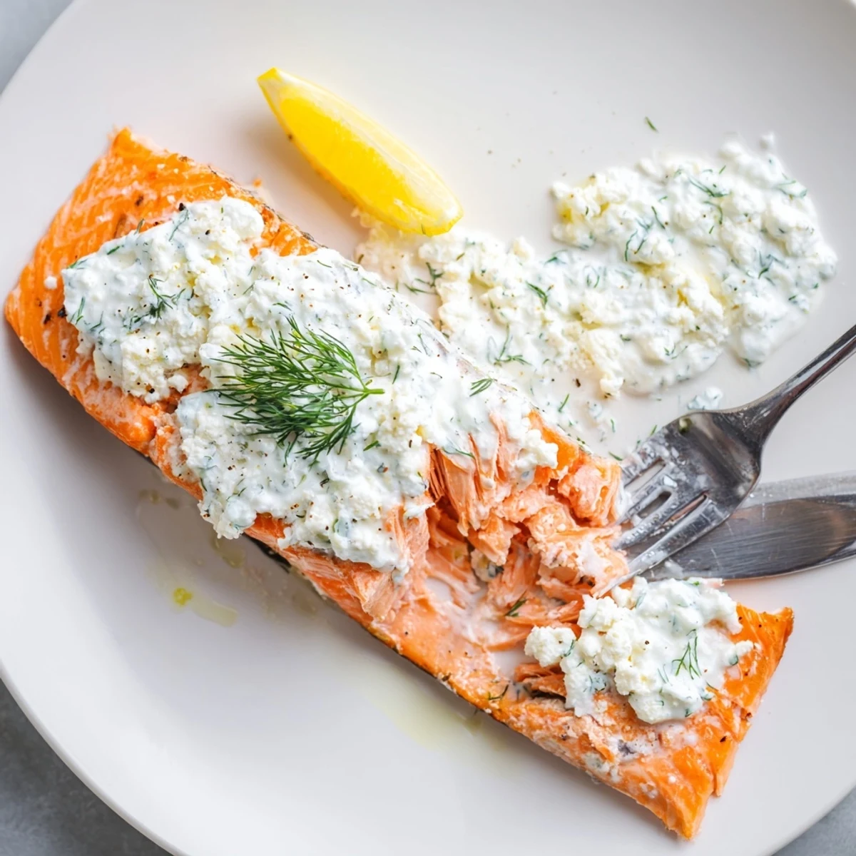 Grilled Salmon with Feta Dill Sauce, bright lemon garnish and herb aroma
