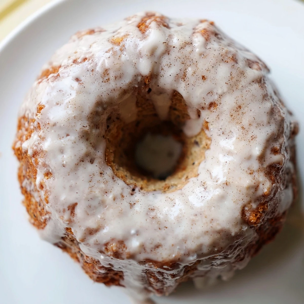 Soft banana bread donuts cooling on wire rack with sweet powdered sugar glaze