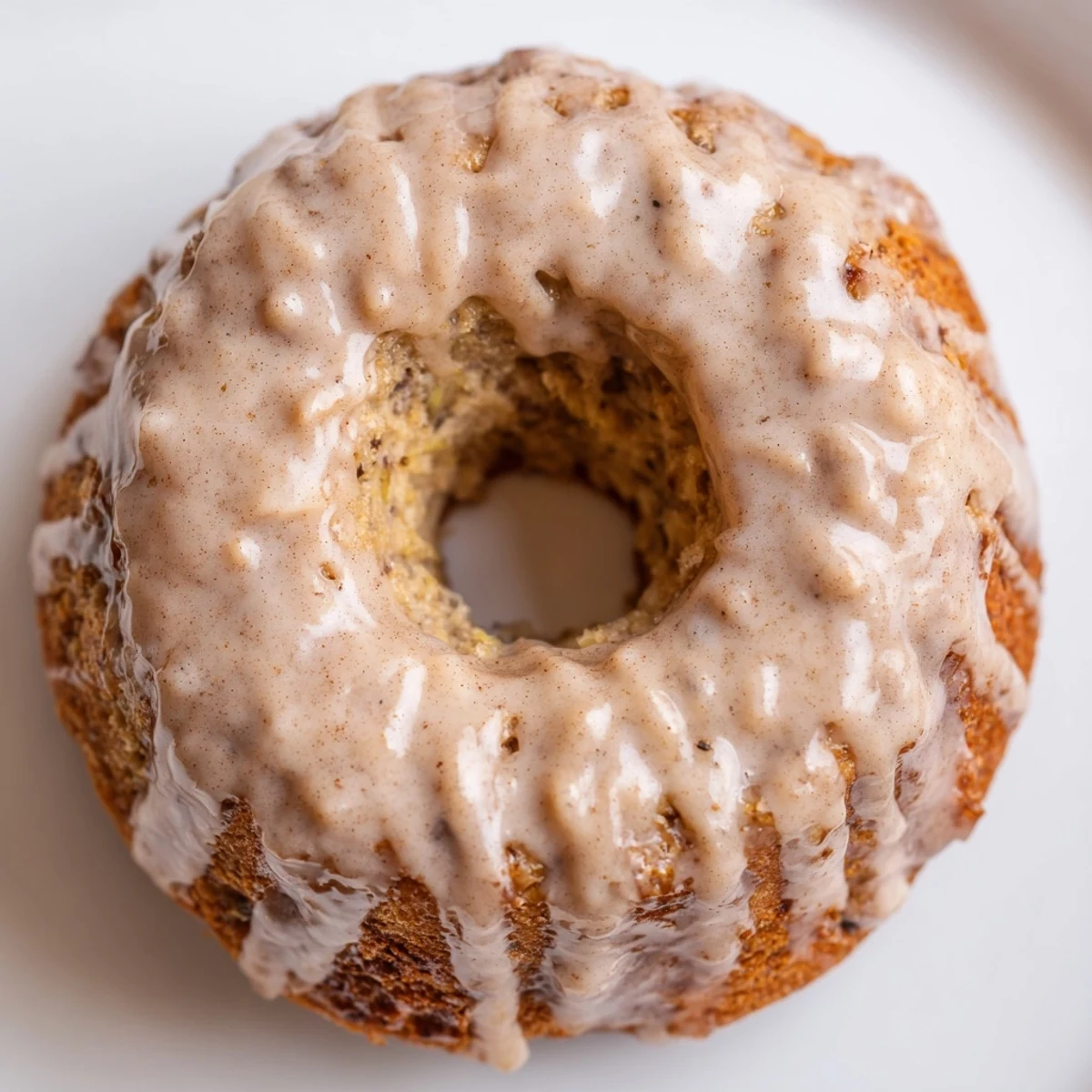 Freshly baked banana bread donuts with golden brown tops and cinnamon dusting