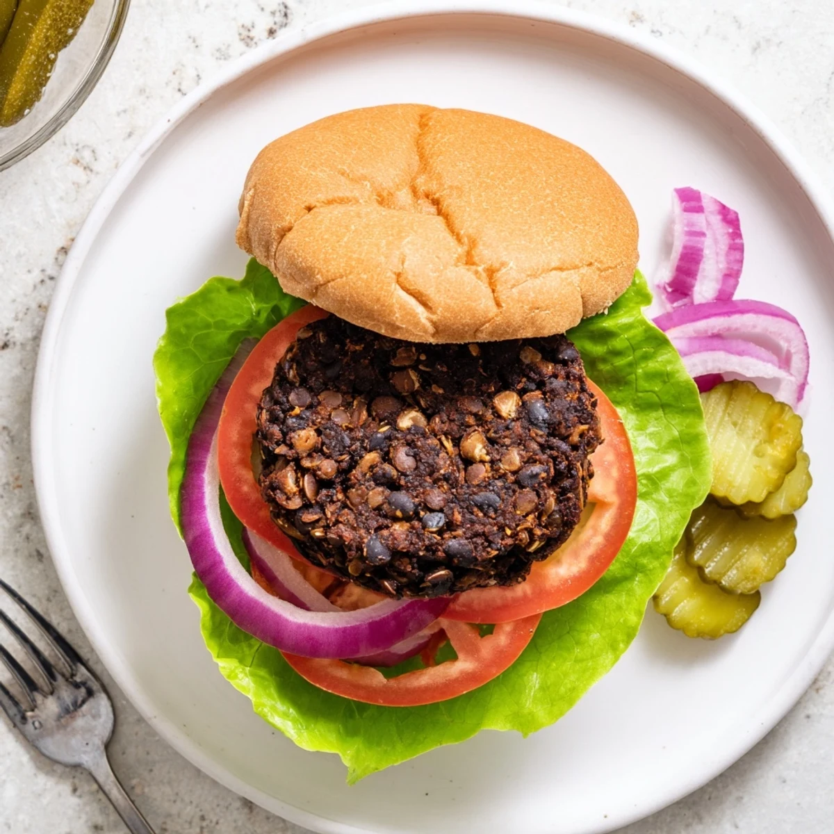 Golden veggie burgers recipe stacked on toasted buns with fresh lettuce, tomato, and melted cheese