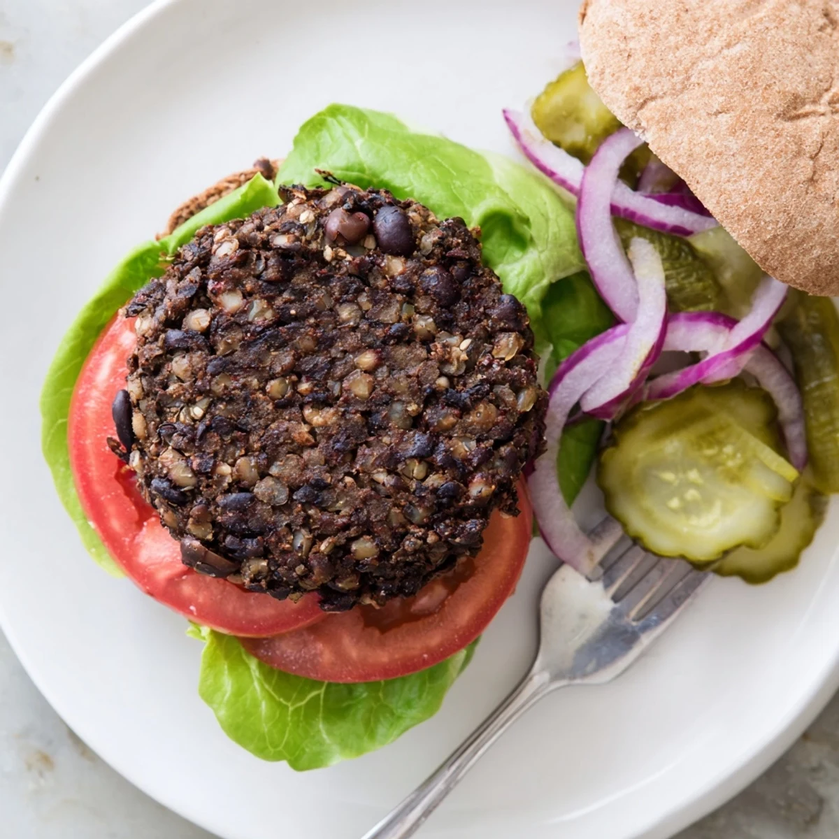 Hearty black bean veggie burgers recipe sizzling on a grill with grill marks and crisp edges