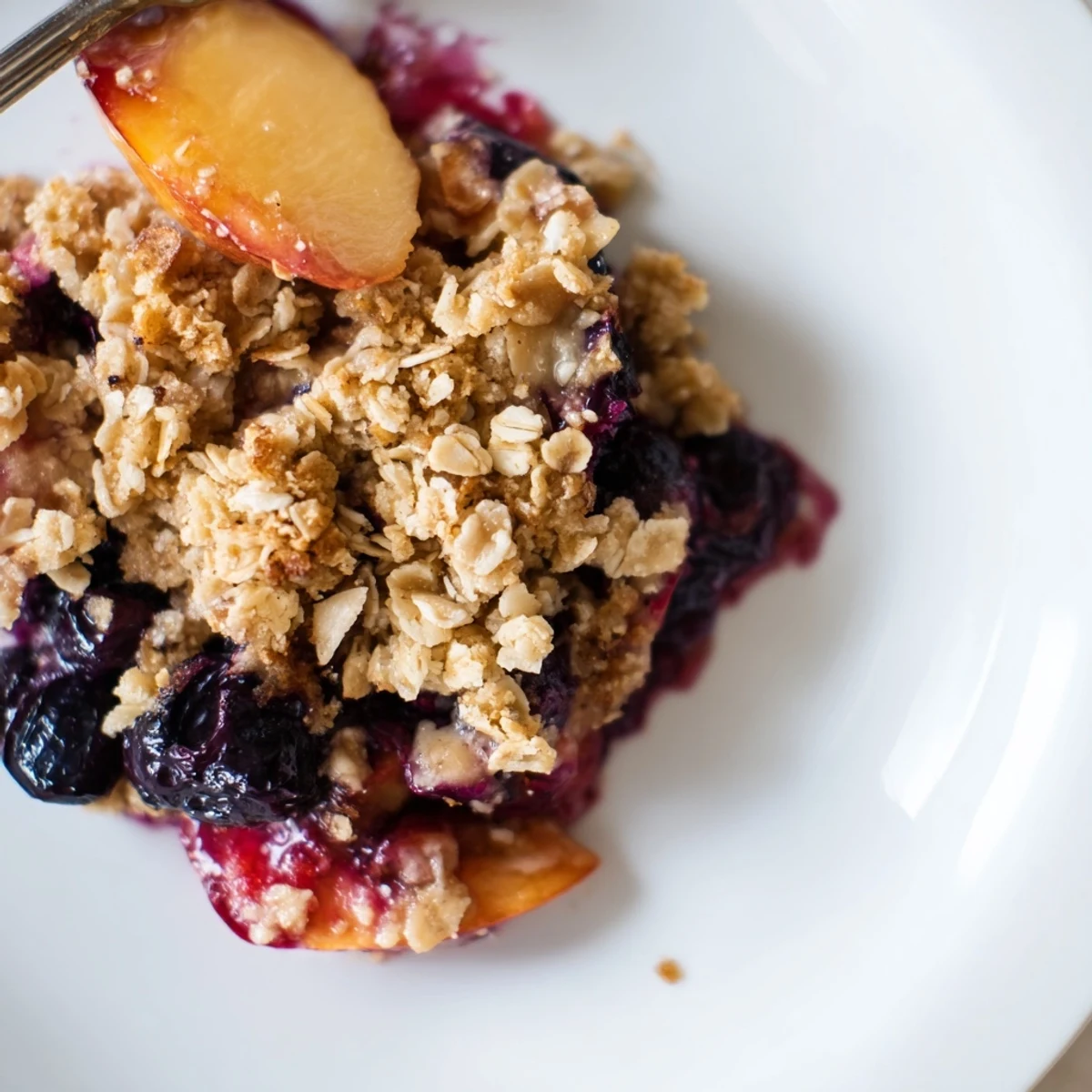 Warm Blueberry Peach Crumble in a ceramic dish, oat crumble crisp