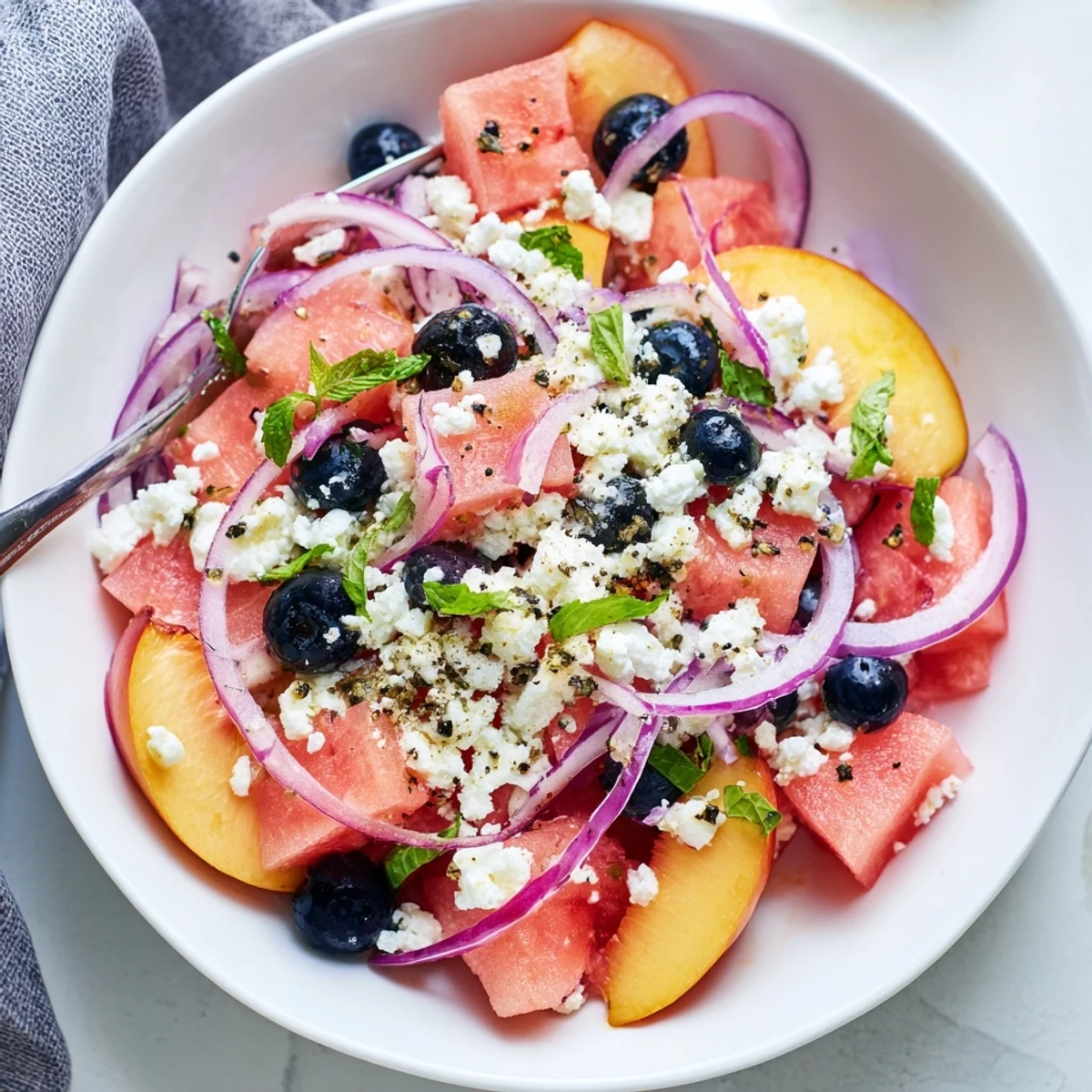 Chilled Peach Watermelon Salad With Feta on platter, basil, lime drizzle
