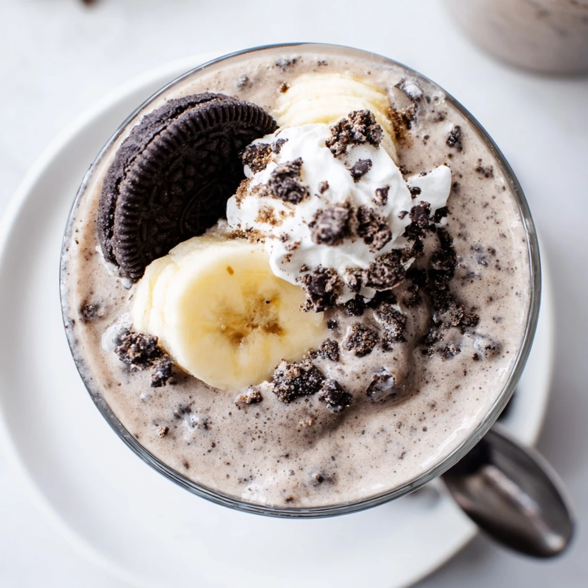 Cookies And Cream Protein Shake in a tall glass, creamy and cold