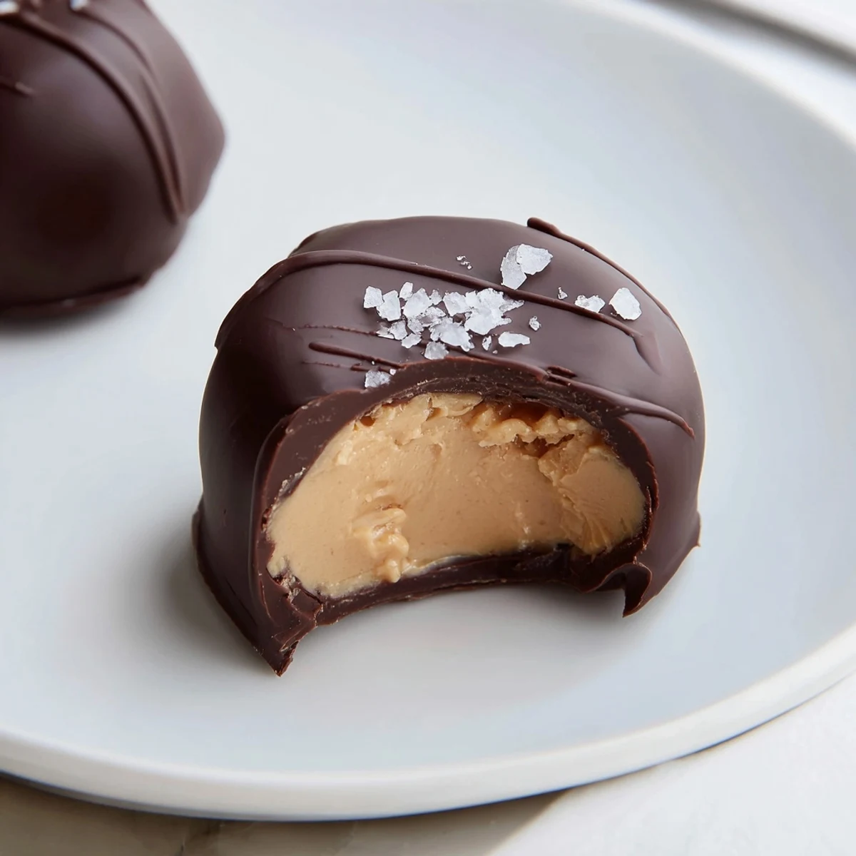 Frozen Peanut Butter Greek Yogurt Bites Dipped In Dark Chocolate With Sea Salt, stacked