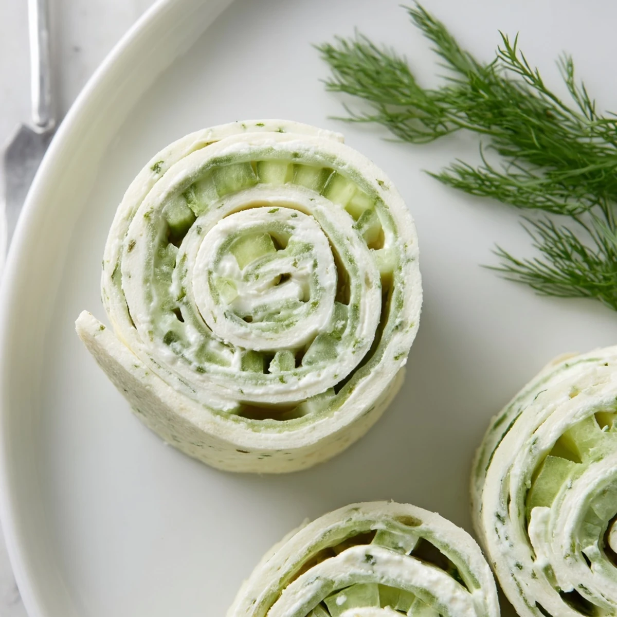 Chilled Cucumber And Dill Pinwheels rolled in soft tortillas, perfect picnic snack