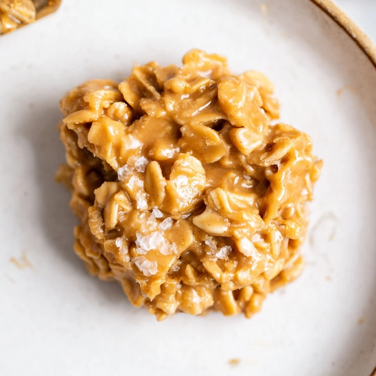 Peanut Butter No Bake Cookies on plate beside cold glass of milk