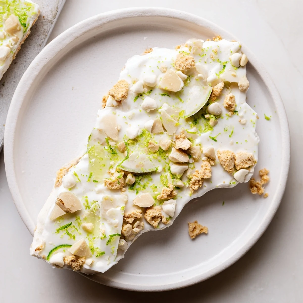 Frosty, tangy Key Lime Pie Yogurt Bark topped with crunchy graham cracker crumbs