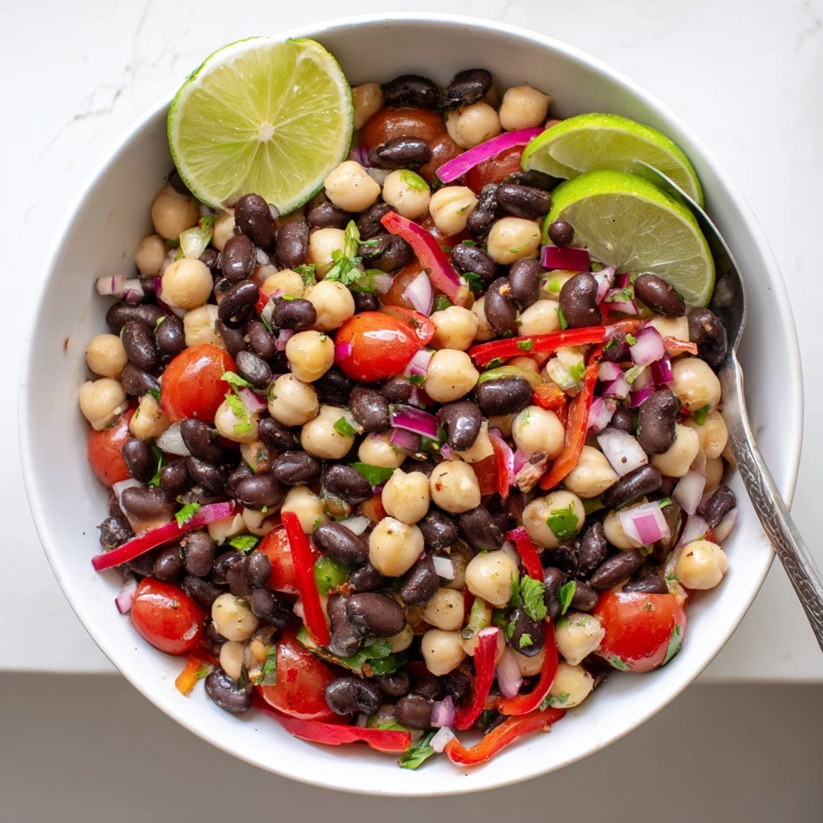 Chilled Marinated Cilantro Lime Bean Salad served with lime wedges and crunchy tortilla chips