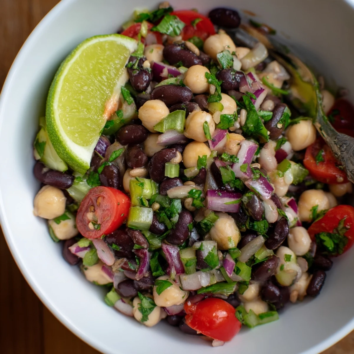 Bright Marinated Cilantro Lime Bean Salad tossed with red peppers, tomatoes, and jalapeño