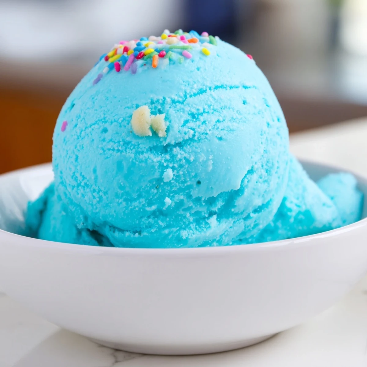 Smooth Blue Moon Ice Cream served in a chilled dish topped with rainbow sprinkles
