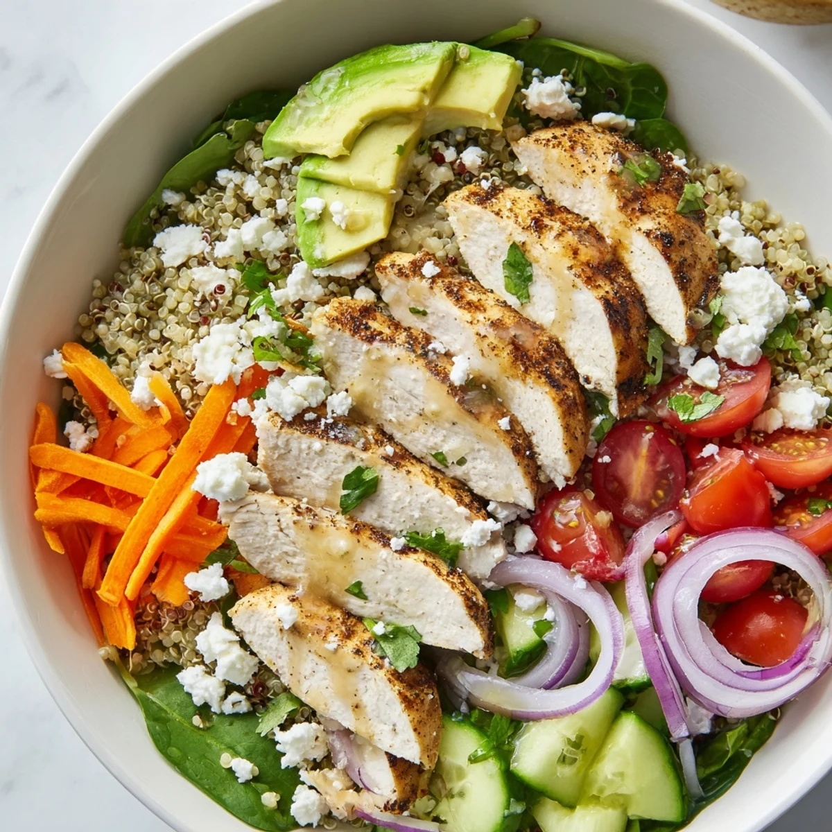 Golden sliced chicken grain bowl with vivid veggies and zesty lemon herb drizzle