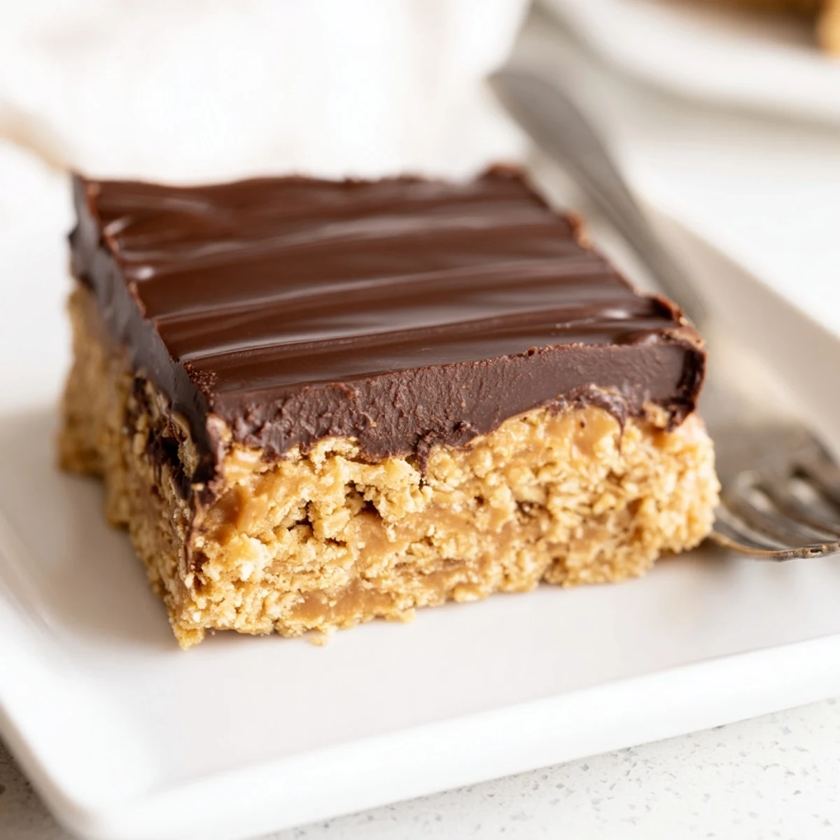 Creamy peanut butter dessert bars with fudgy chocolate layer, sliced and ready for serving