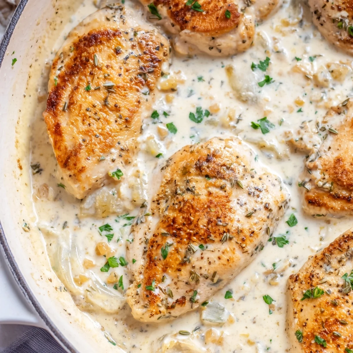 Tender Cream Cheese Chicken breasts smothered in a silky herb-flecked cream sauce